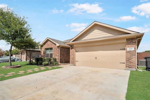 single story home with central AC, a front yard, and a garage