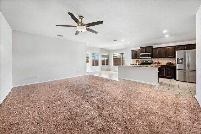 interior space featuring ceiling fan and light colored carpet