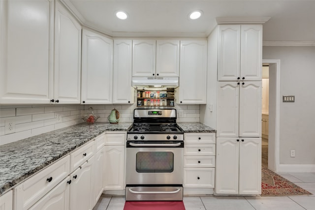 kitchen with white cabinetry, dark stone countertops, gas range, and light tile patterned floors