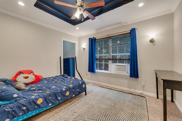 bedroom with ornamental molding, light colored carpet, ceiling fan, and a tray ceiling