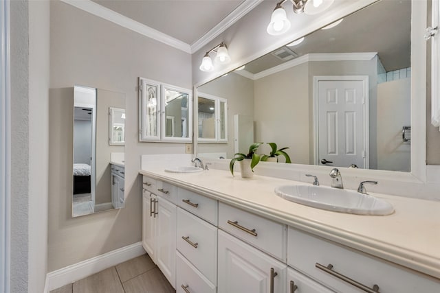 bathroom with ornamental molding, tile patterned flooring, and vanity