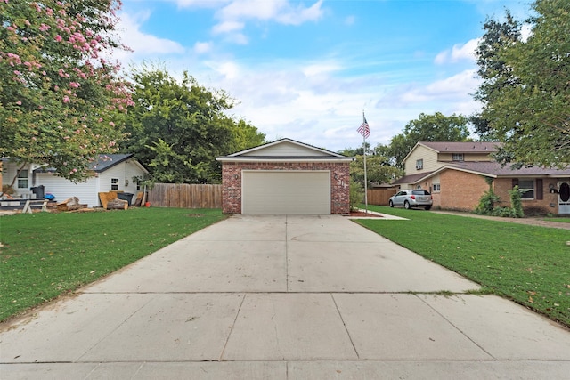 view of front of property featuring a front lawn and a garage