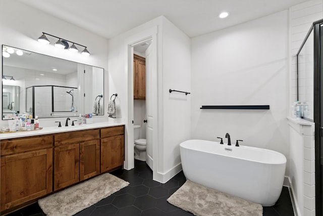 full bathroom featuring vanity, toilet, independent shower and bath, and tile patterned flooring