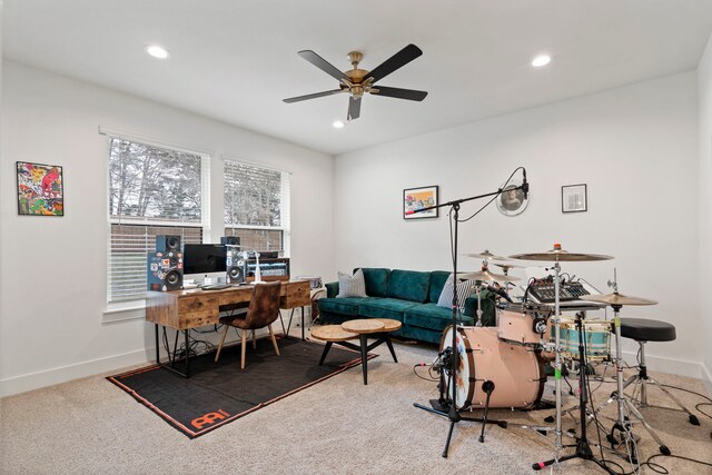 carpeted office featuring ceiling fan