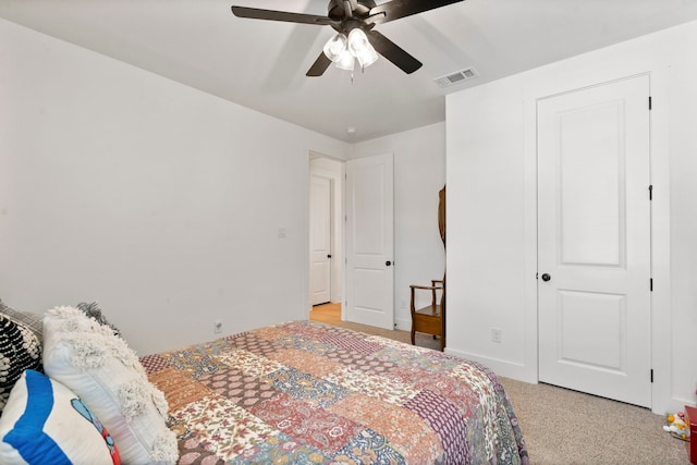 bedroom featuring ceiling fan and light carpet