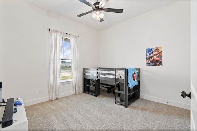 bedroom with ceiling fan and light carpet