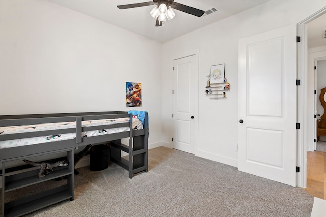 home office with ceiling fan and carpet floors