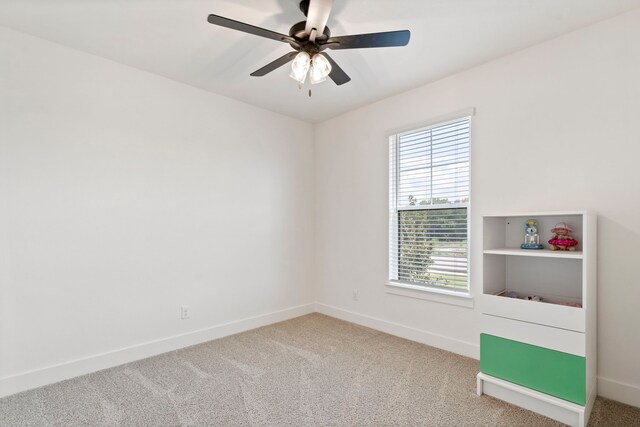 interior space featuring ceiling fan and light colored carpet