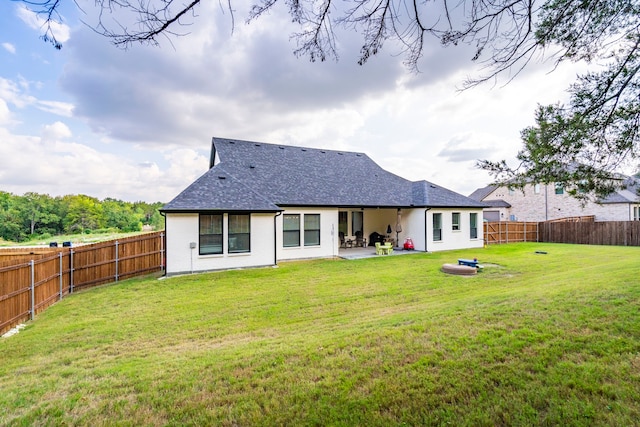 rear view of property with a lawn and a patio area