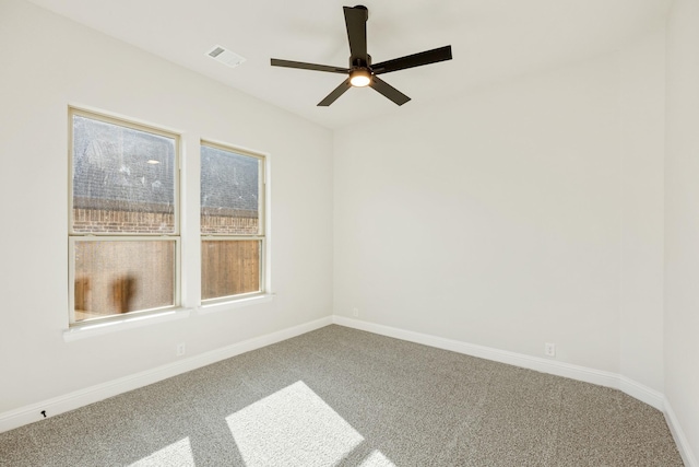 carpeted empty room featuring ceiling fan