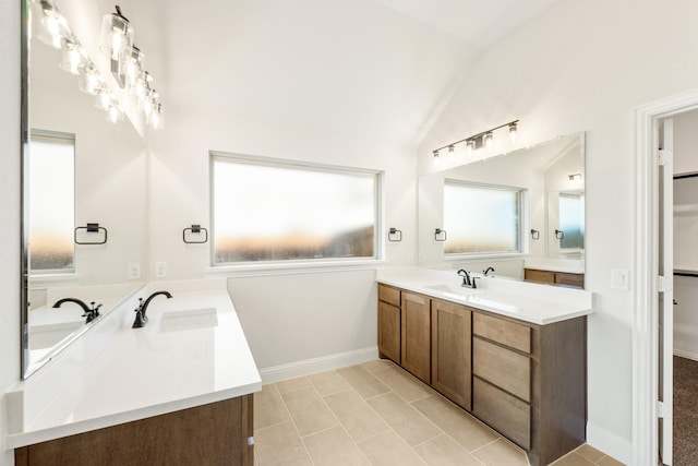 bathroom featuring vanity and lofted ceiling