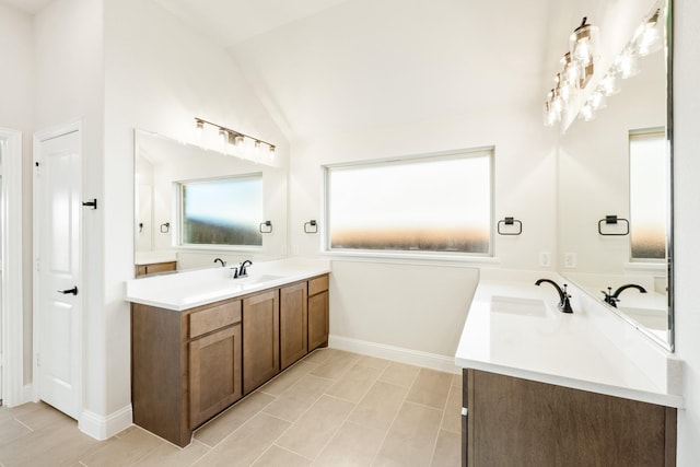 bathroom featuring vanity and lofted ceiling