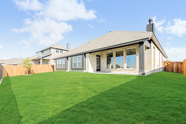 rear view of house with a yard