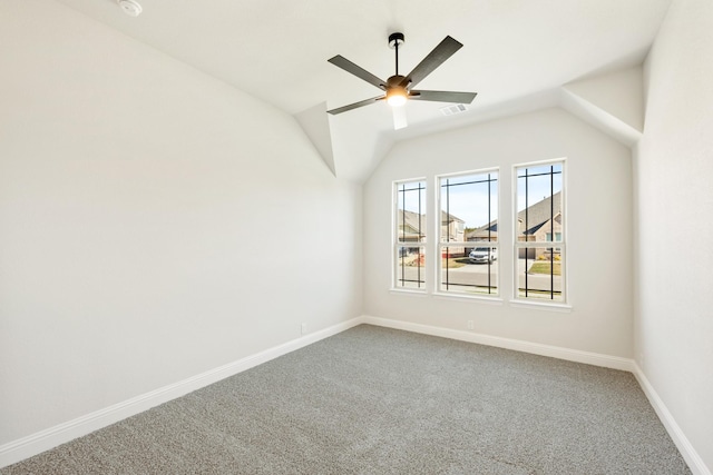 carpeted empty room featuring ceiling fan and lofted ceiling