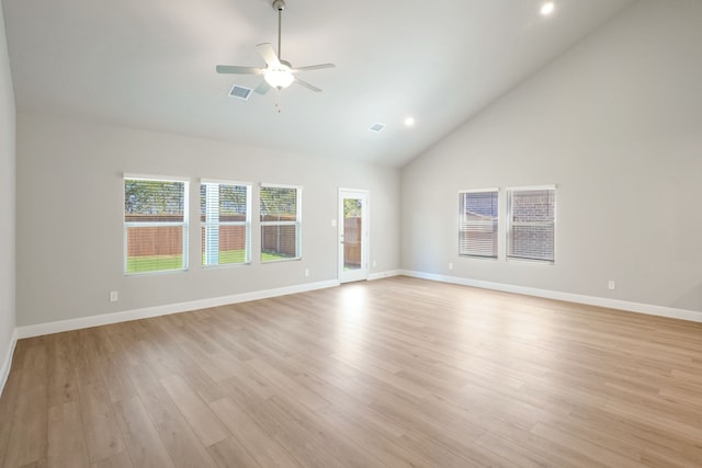 unfurnished living room with high vaulted ceiling, light wood-type flooring, and ceiling fan