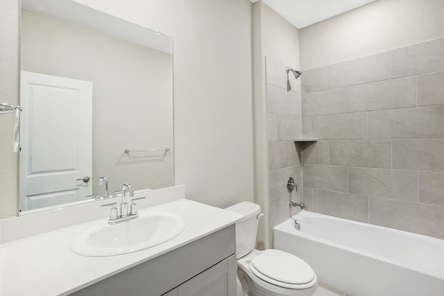 full bathroom featuring vanity, tiled shower / bath combo, and toilet