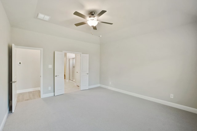 unfurnished bedroom with ceiling fan and light carpet