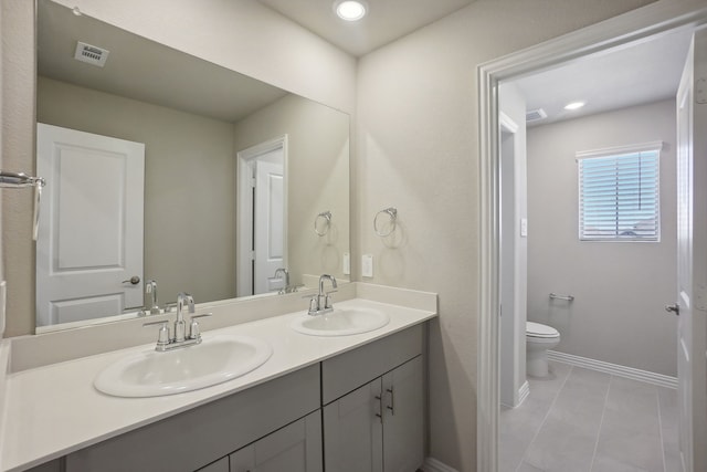 bathroom featuring vanity, toilet, and tile patterned floors