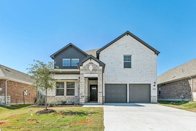 view of front of house featuring a front yard and a garage