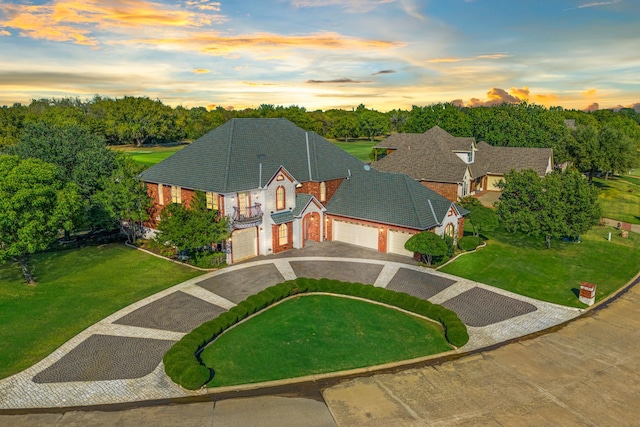 view of front of house with a garage and a yard