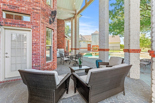 view of patio with an outdoor living space, grilling area, and a fenced in pool