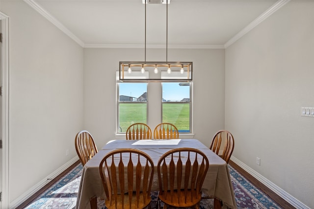 dining space with ornamental molding and wood-type flooring