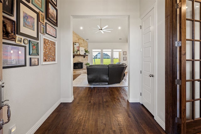 hall featuring vaulted ceiling and dark hardwood / wood-style flooring