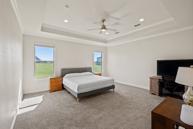 carpeted bedroom featuring ornamental molding, a raised ceiling, and ceiling fan