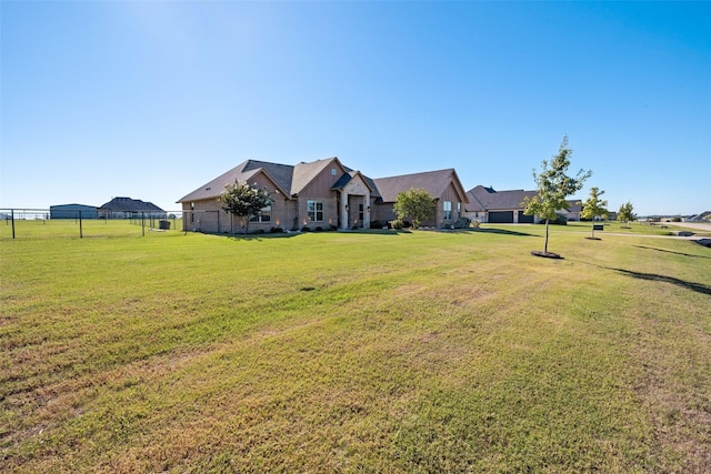 view of front facade with a front yard and fence