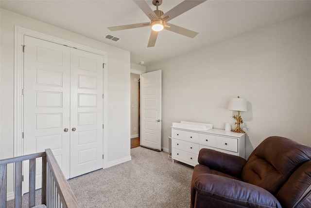 living area featuring light carpet and ceiling fan