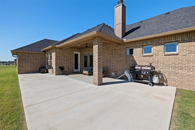 rear view of house with a lawn and a patio area