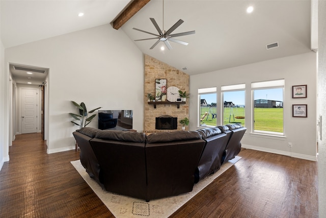 living room featuring high vaulted ceiling, beamed ceiling, a stone fireplace, dark wood-type flooring, and ceiling fan