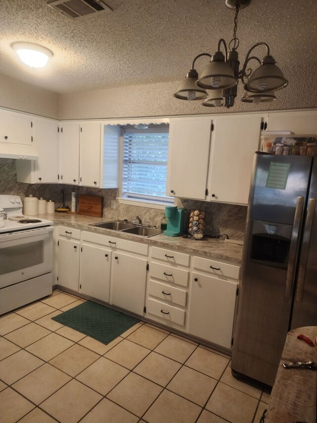 kitchen featuring tasteful backsplash, sink, white cabinets, stainless steel refrigerator with ice dispenser, and white range with electric cooktop