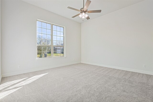 unfurnished room featuring light colored carpet and ceiling fan