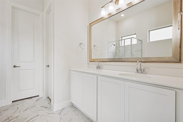 bathroom featuring a shower with door and vanity