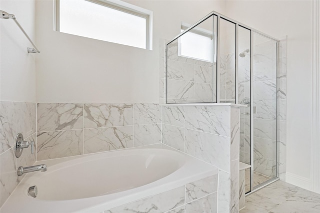 bathroom featuring shower with separate bathtub