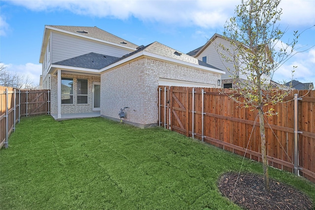 rear view of property featuring a lawn and a patio area