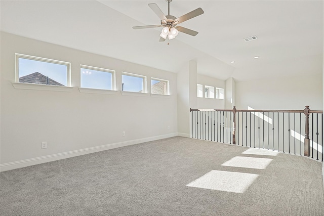 unfurnished room with ceiling fan, lofted ceiling, and carpet flooring