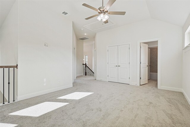 carpeted empty room featuring lofted ceiling