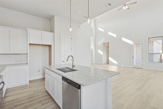 kitchen featuring white cabinetry, dishwasher, and sink