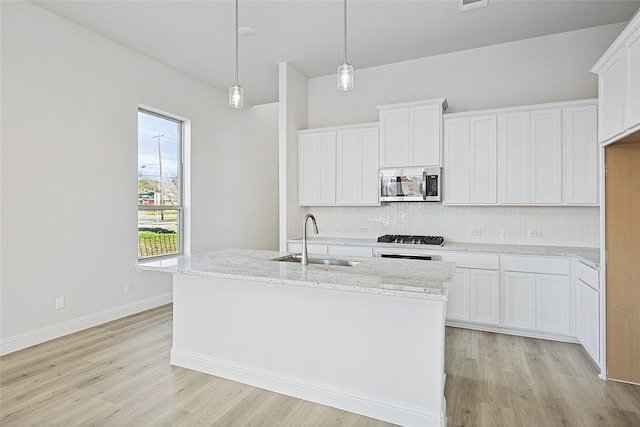 kitchen with appliances with stainless steel finishes, sink, and white cabinets