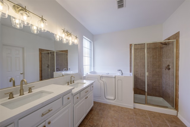 bathroom with independent shower and bath, vanity, and tile patterned floors