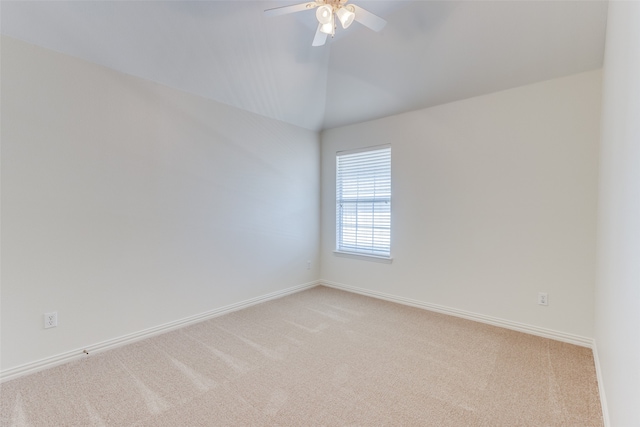 carpeted empty room featuring lofted ceiling and ceiling fan