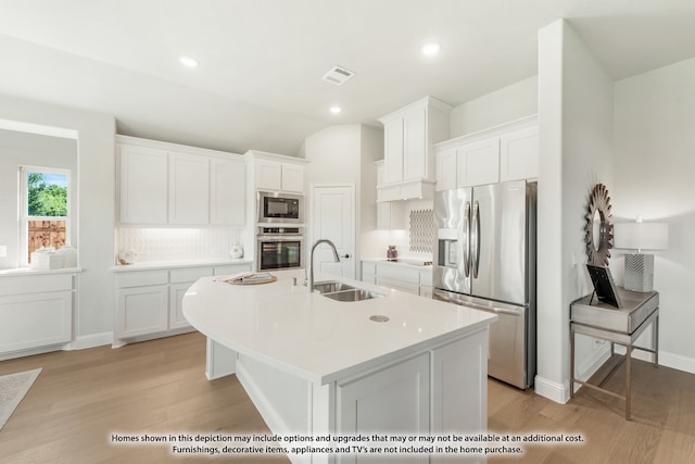 kitchen with white cabinetry, light hardwood / wood-style flooring, and stainless steel appliances