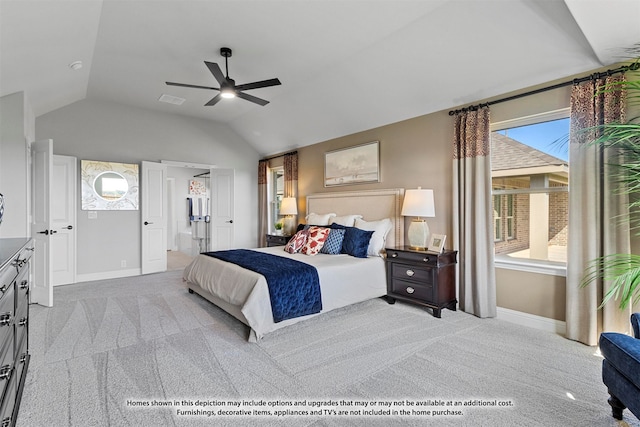 bedroom with light carpet, connected bathroom, vaulted ceiling, and ceiling fan