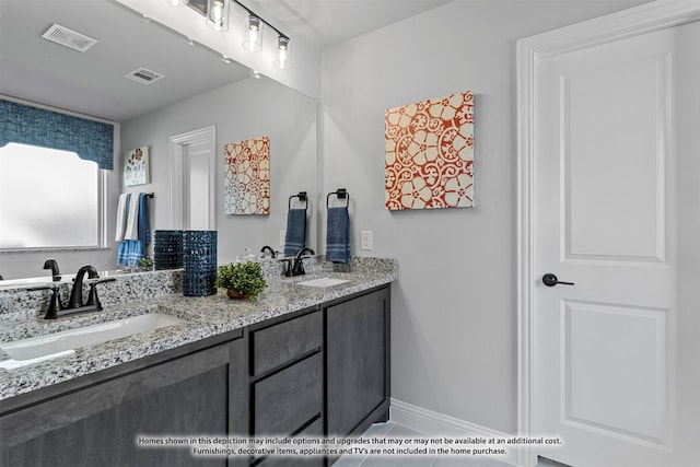 bathroom featuring tile patterned flooring and vanity