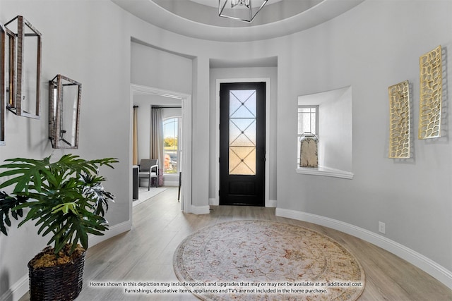 entryway with light wood-type flooring and a high ceiling