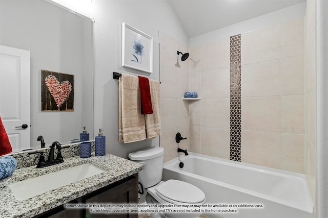 full bathroom with lofted ceiling, tiled shower / bath combo, vanity, and toilet