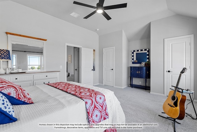 carpeted bedroom with ceiling fan and vaulted ceiling