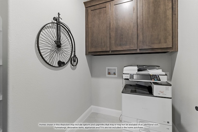 laundry room with light tile patterned floors, washer hookup, and cabinets